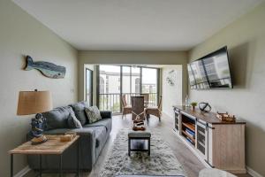 a living room with a couch and a table at Waterfront Marco Island Condo with Pool and Hot Tub! in Marco Island