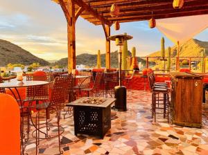 a patio with tables and chairs and a grill at Casa Concepcion Suites in Punta Arena