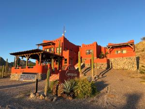 an orange building with a sign in front of it at Casa Concepcion Suites in Punta Arena