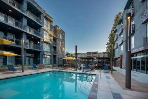 a swimming pool in front of a building at KING BED Modern 2 Bed 2 Bath Pool & Hot Tub in Mountain View