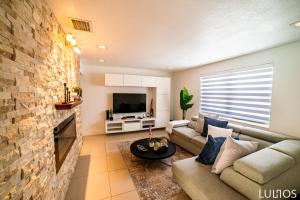 a living room with a couch and a fireplace at Calle 8 Marvel - Miami Oasis Retreat L55 in Miami