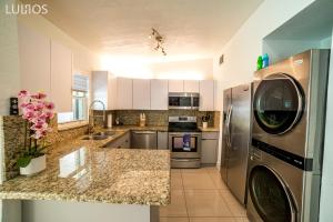 a kitchen with a washer and dryer at Calle 8 Marvel - Miami Oasis Retreat L55 in Miami