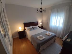 a bedroom with a bed with two towels on it at EL RETIRO in Sanlúcar de Barrameda +12 photos