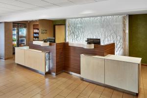 a lobby with two reception desks in a building at Fairfield Inn & Suites by Marriott Gainesville in Gainesville