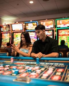 um homem e uma mulher sentados numa mesa de casino em Courtyard Aguadilla em Aguadilla