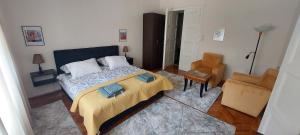 a bedroom with a bed and a chair at Bohemian in Belgrade
