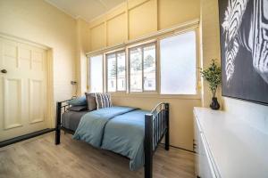 a bedroom with a bed and a window at Sea La Vie on Durham in Glenelg