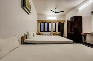a bedroom with a large bed and a couch at Hotel Natraj in Rānchī