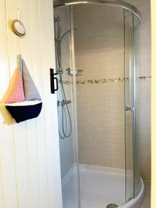 a shower with a glass door in a bathroom at Traditional 2 bedroom Cottage in Stratford-upon-Avon