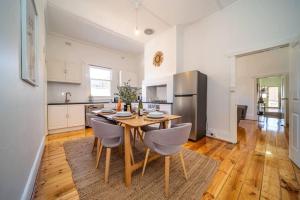 a kitchen and dining room with a wooden table and chairs at Kairos in Keswick at Keswick in Keswick