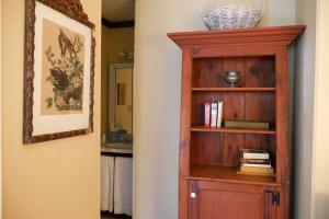 a room with a wooden book shelf with books at Race Brook Lodge in Sheffield