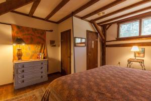 a bedroom with a bed and a dresser and a window at Race Brook Lodge in Sheffield