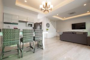 a kitchen and living room with a couch and a table at Koh Chang Luxury Pool Villas in Ko Chang