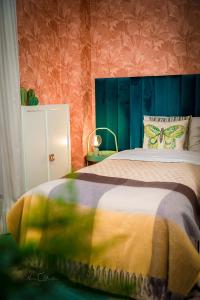 a bedroom with a bed with a butterfly pillow at Harmony Boutique Hotel in Drawsko Pomorskie