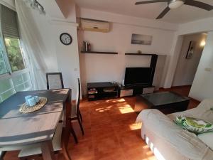 a living room with a table and a couch at CALZADA Homes in Almería