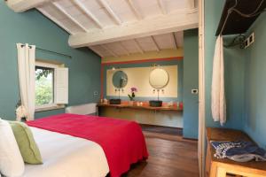 サン・カシャーノ・デイ・バーニにあるVillavetrichinaの青い壁のベッドルーム1室、ベッド1台(赤い毛布付)