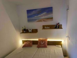 a bedroom with a bed with two pillows on it at Kleines Glück Grömitz in Grömitz