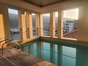 a swimming pool on the balcony of a building at Portonovi - Marina Residences Sea View Apartment in Herceg-Novi