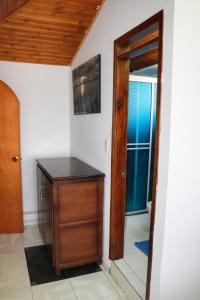 a room with a wooden cabinet and a door at Hospedaje Costa Azul in Aquitania