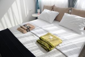 a white bed with towels and pillows on it at El Angel by Ntinos in Kremasti +118 photos