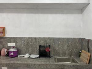 a kitchen counter with a sink and a stove at Awesome Guest Mirissa in Mirissa