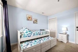 a bedroom with two bunk beds with blue walls at Oceanview Resort*Hot tub*North Topsail Beach in North Topsail Beach