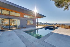 a house with a swimming pool in front of it at Luxe, Modern Studio with Sweeping City Views! in Boise