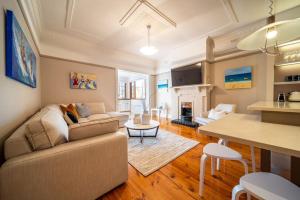 a living room with a couch and a table at The Fourth Sussex House in Glenelg