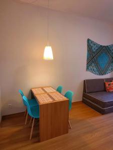 a living room with a table and chairs and a couch at Apê Turquesa, 190 m da praia do Leme in Rio de Janeiro