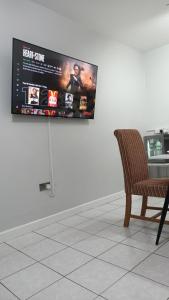 a flat screen tv hanging on a wall at Lister Park Bradford Stylish 1bed Coach House - Quiet & Tranquil Cottage & Parking in Bradford