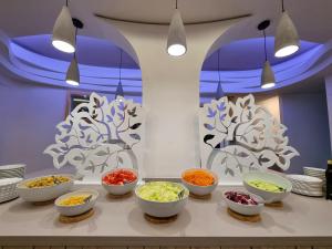 a table with bowls of different types of vegetables at Eco Hotel Montemerlo in Fetovaia
