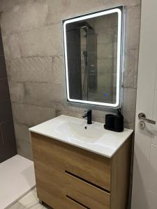 a bathroom with a sink and a mirror at Casa Blanca in Torrox Costa