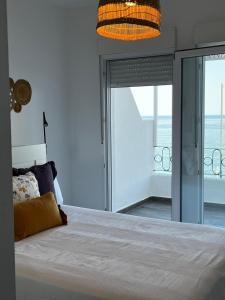 a bedroom with a bed with a view of the ocean at Casa Blanca in Torrox Costa