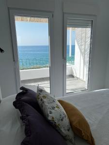 a bedroom with a bed and a view of the ocean at Casa Blanca in Torrox Costa