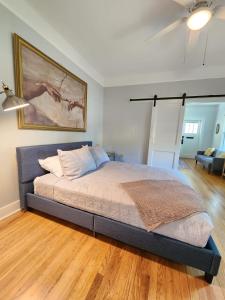 a bedroom with a bed and a living room at Cozy Vintage Bungalow @Mills50 District in Orlando