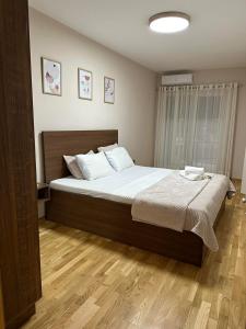 a bedroom with a large bed with white sheets at Apartment33 in Strumica