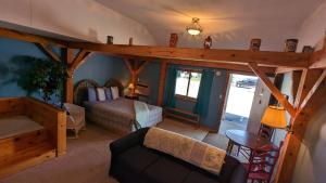 a room with a bedroom with a bed and a couch at The Nova Motel in Ludington