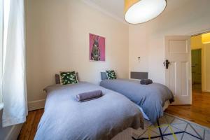 a bedroom with two beds in a room at The Oxford Hyde Park 4BR Cottage in Unley