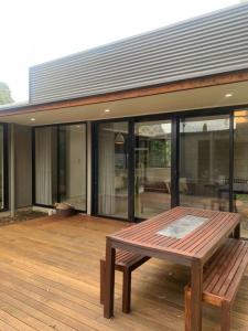 a wooden deck with a bench on top of a house at The Architects House Villa 1 and 2 in Hahndorf