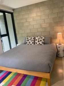 a bedroom with a large bed with a colorful rug at The Architects House Villa 1 and 2 in Hahndorf