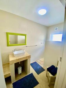 a bathroom with a sink and a mirror at Poolstraat 16 in Agulhas +25 photos
