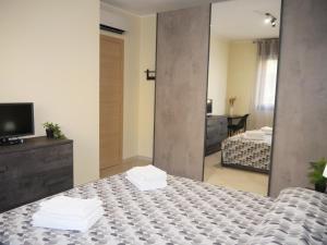 a bedroom with a large mirror and a bed at Nicolo's Home in Quartu SantʼElena