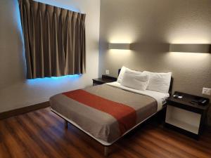 a bed in a small room with a window at Motel 6-Biloxi, MS - Beach in Biloxi