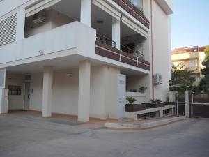 a white building with a balcony on the side at Nicolo's Home in Quartu SantʼElena