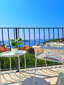 a table and a chair on a balcony with a view at Ida view in Hvar