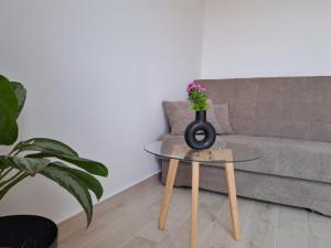 a living room with a couch and a table with a vase on it at Ida view in Hvar
