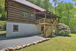 a house with a staircase leading up to a building at Creekside cabin w/ hot tub, fireplace & trail in Newland