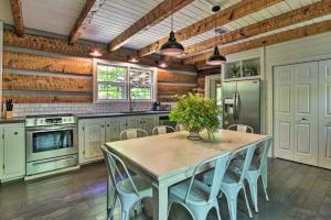 a kitchen with a table and chairs in it at Creekside cabin w/ hot tub, fireplace & trail in Newland