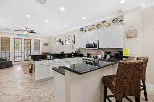 a kitchen with white cabinets and black counter tops at Angler's Reef Resort in Islamorada