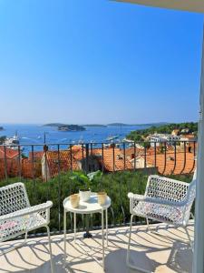 a table and chairs on a patio with a view of the ocean at Ida view in Hvar